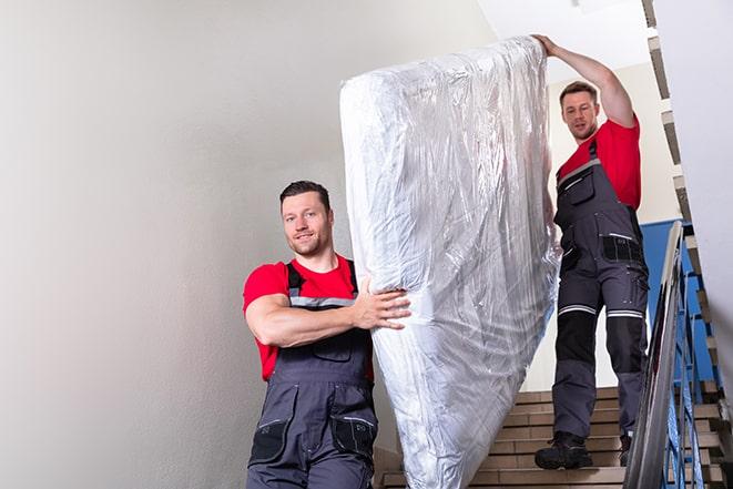 heavy lifting as box spring is transported out of a building in Marlborough, CT