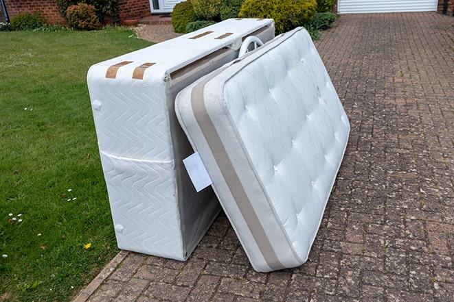 mattress being loaded onto a removal truck